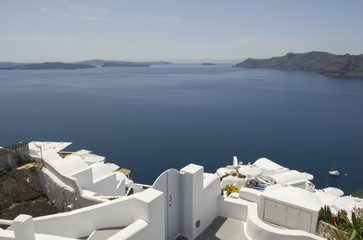 Traditional view of houses above the sea in Oia, Santorini, Greece.