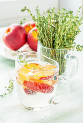 refreshing fizzy drink with slices of peach, nectarine,
