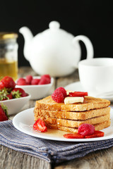 Fresh toast with raspberry and strawberry on grey wooden backgro
