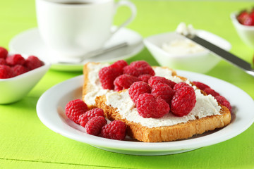 Fresh toast with raspberry on green wooden background