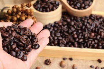 Roasted coffee beans on sack brown background.