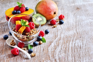 Yogurt with granola with berries and fruits, for healthy breakfast, selective focus