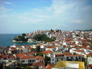 Panoramic view on the picturesque town of Skiathos, capital of the Greek island of the same name, which belongs to the Northern Sporades group, on a sunny day.