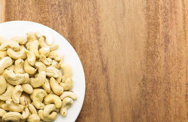 Cashew nuts on a rustic wooden against  wood background