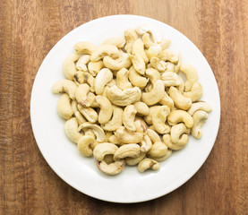 Cashew nuts on a rustic wooden against  wood background