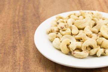 Cashew nuts on a rustic wooden against  wood background
