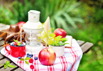 Ripe apples and berries, vintage lamp or lantern, selective focus