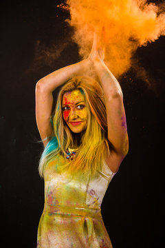 Beautiful young woman with colored powder