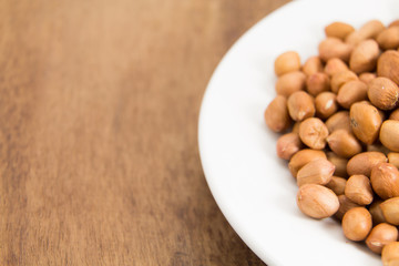 peanuts without shell on wooden background