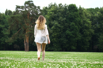 Young beautiful blonde woman walking away