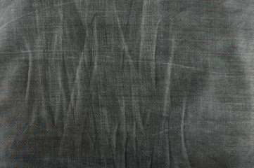 Dark grey jeans pattern with wrinkles