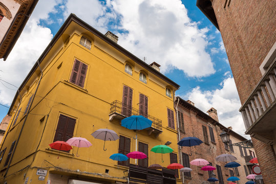 Ancient medieval street in the downtown of Ferrara city with umb
