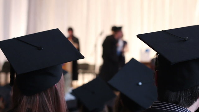 Young people in black academic caps, gowns. Hope for successful career in future