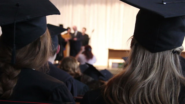 Student receiving higher education certificate from dean, graduation ceremony