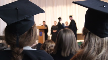 Many people at ceremony to celebrate graduation. Dean shaking student's hand