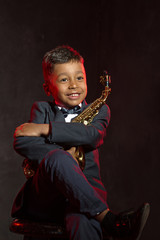 six years old boyhug his saxophone