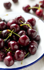 sweet cherry on a plate on wooden table