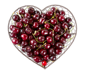 cherries in a heart-shaped metallic basket isolated on white