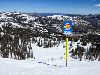 Caution, expect unmarked obstacles sign at Wolf Creek ski area in Colorado