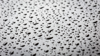 Macro water drop on black stone texture