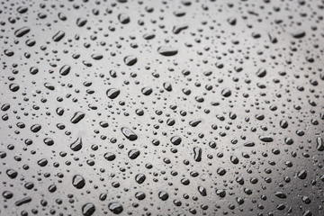 Macro water drop on black stone texture