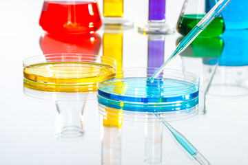 science Laboratory glassware pipette drop, reflective white back