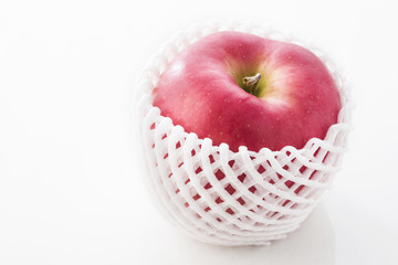 Fresh japanese apple with foam net protection on background