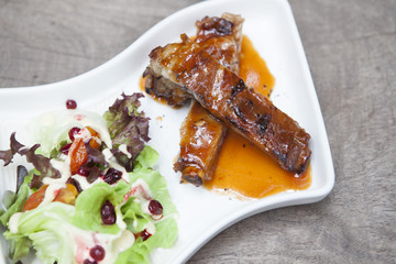 Pork rib stack with red sauce with salad
