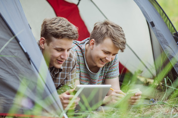Young people are in a tent with digital tablet
