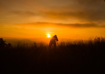 Silhouette of photography on the cliff