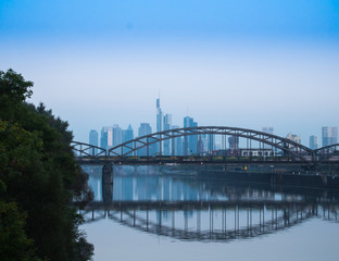 Fototapeta na wymiar Railway bridge and the skyline of Frankfurt, Germany