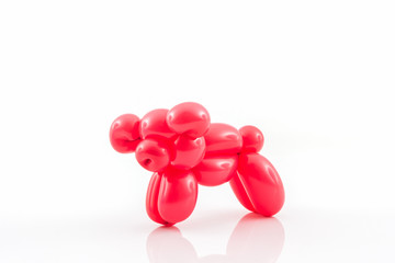 Balloon animal of red pig action pose.