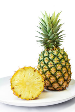 Pineapple with slices on a white dish, Fruit.