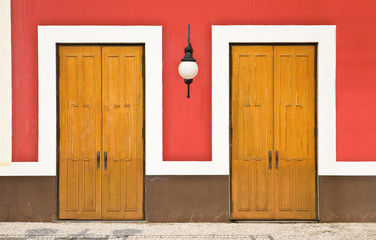 Two doors against color wall