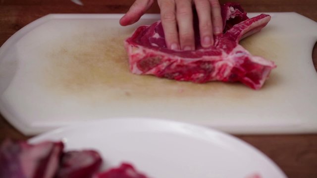 HD 1080 close up: chef finely chopping beef steak using sharp knife; 