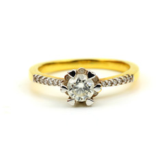 close up of Women's golden wedding ring with diamond isolated on