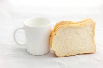 Empty coffee cup or coffee mug and sliced bread isolated on whit