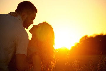 romantic sensual young couple in love kissing at the sunset - Powered by Adobe