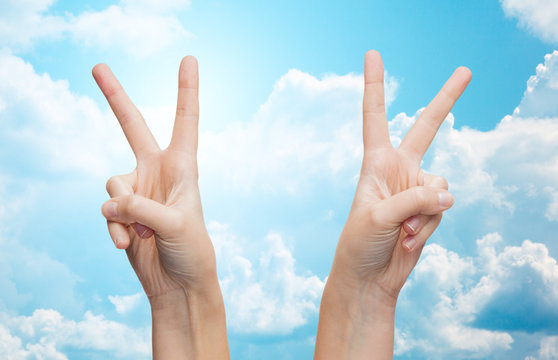 woman hands showing victory or peace sign