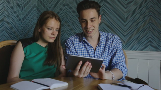 Online Photo Album
shot of a friend, showing each other photos from your vacation.

The plate holding a man and they are actively discussing what is happening on the screen.