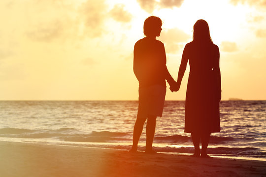 Romantic couple on the beach at sunset