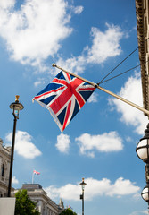 union jack flag waving on london city street