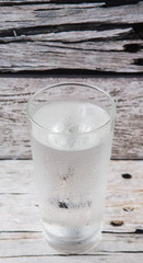 A glass of water over wooden background