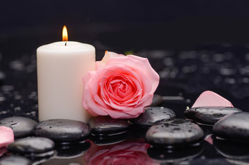 Still life with pink rose with candle and therapy stones 