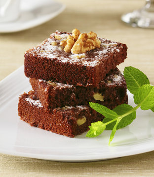 Three slices of chocolate brownie piled up.