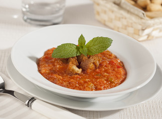 Thick tomato soup with fried bread.
