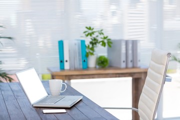 Business desk with laptop and smartphone