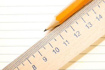 Notepads, pencil and wooden ruler on the old tissue