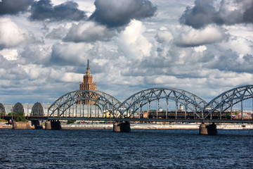 Riga embankment to the bridge on the river and clouds in summer