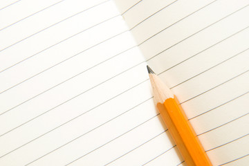 Opened notebook and pencil on the old tissue